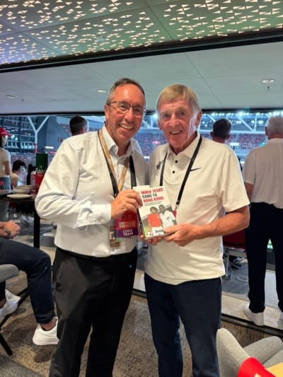 At Kai Tak Stadium, as Liverpool FC play AC Milan: stadium CEO John Sharkey presents Sir Kenny Dalglish with a copy of "When ‘Jesus’ Came to Hong Kong", Derek Currie's book about being the first European football star to play in Asia